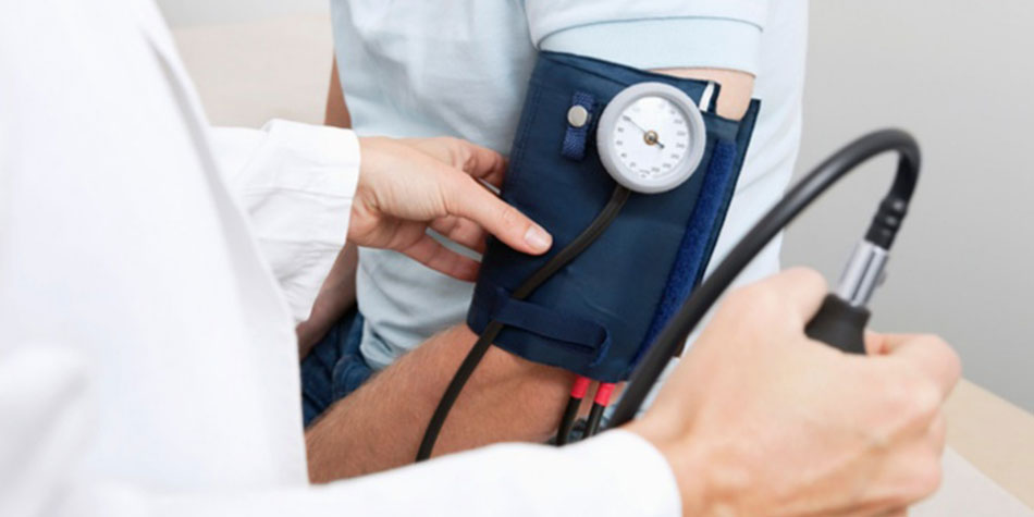 doctor checking a patient's blood pressure
